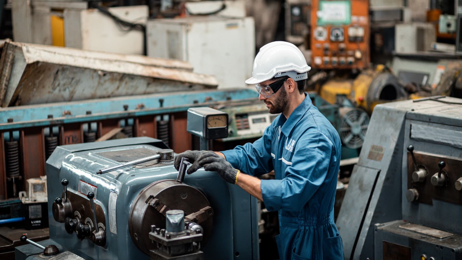 A Silures engineer working on an industrial machine on a workshop floor