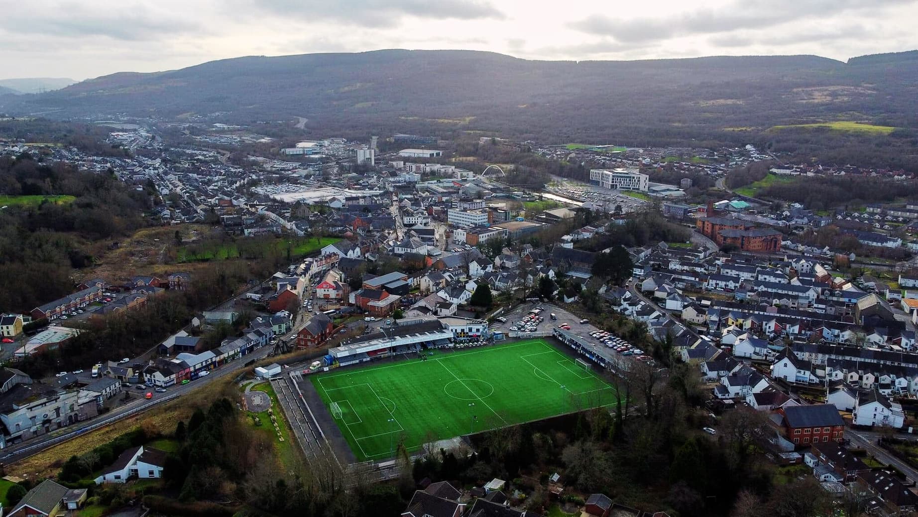 An aerial view of Merthyr Town's ground, with the town and the valley behind it